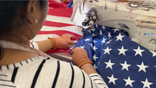 Woman stitching the star field to flag stripes at Allied Materials factory.